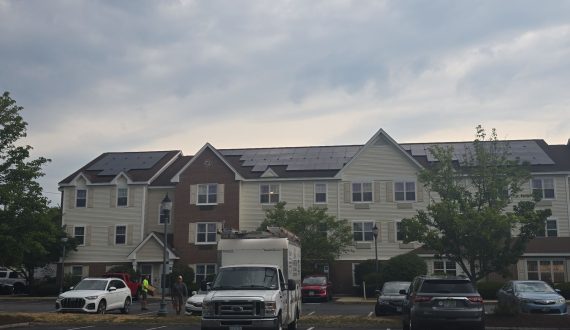 Front view of TownePlace Suites by Marriott in Manchester, NH, featuring rooftop solar panels as part of a commercial solar installation completed by Porter Electrical Contracting.